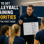 Coach discussing volleyball training priorities with players during a team huddle.